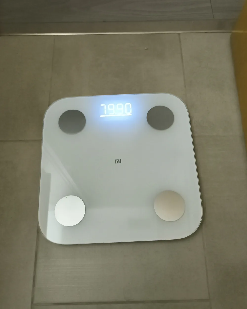 Xiaomi Mi Scale 2 on a bathroom floor, display reading 79.90